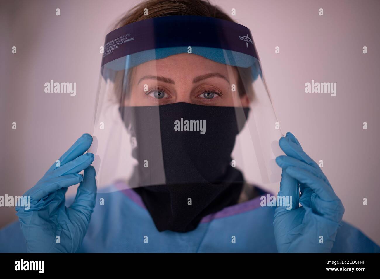 NEW YORK, USA - 28 August 2020 - Master Sgt. Nicole Cafarelli, a member of the 106th Rescue Wing, dons protective gear at the COVID-19 testing site at Stock Photo