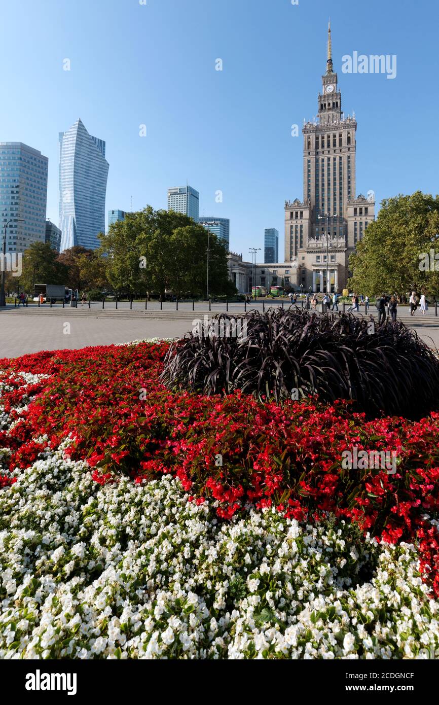 Flowerbed against the Palace of Culture and Science in Warsaw, Poland. Tallest building in Poland was erected in 1955 in 'Seven Sisters' style Stock Photo