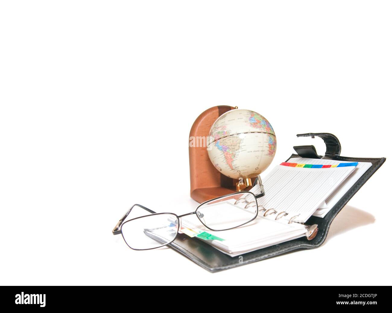 articles of office are a globe, notebook and glass Stock Photo Alamy