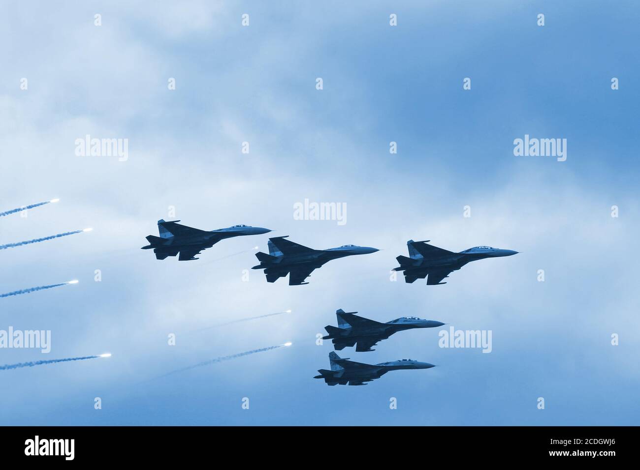 Modern squadron of military planes shooting rocket Stock Photo