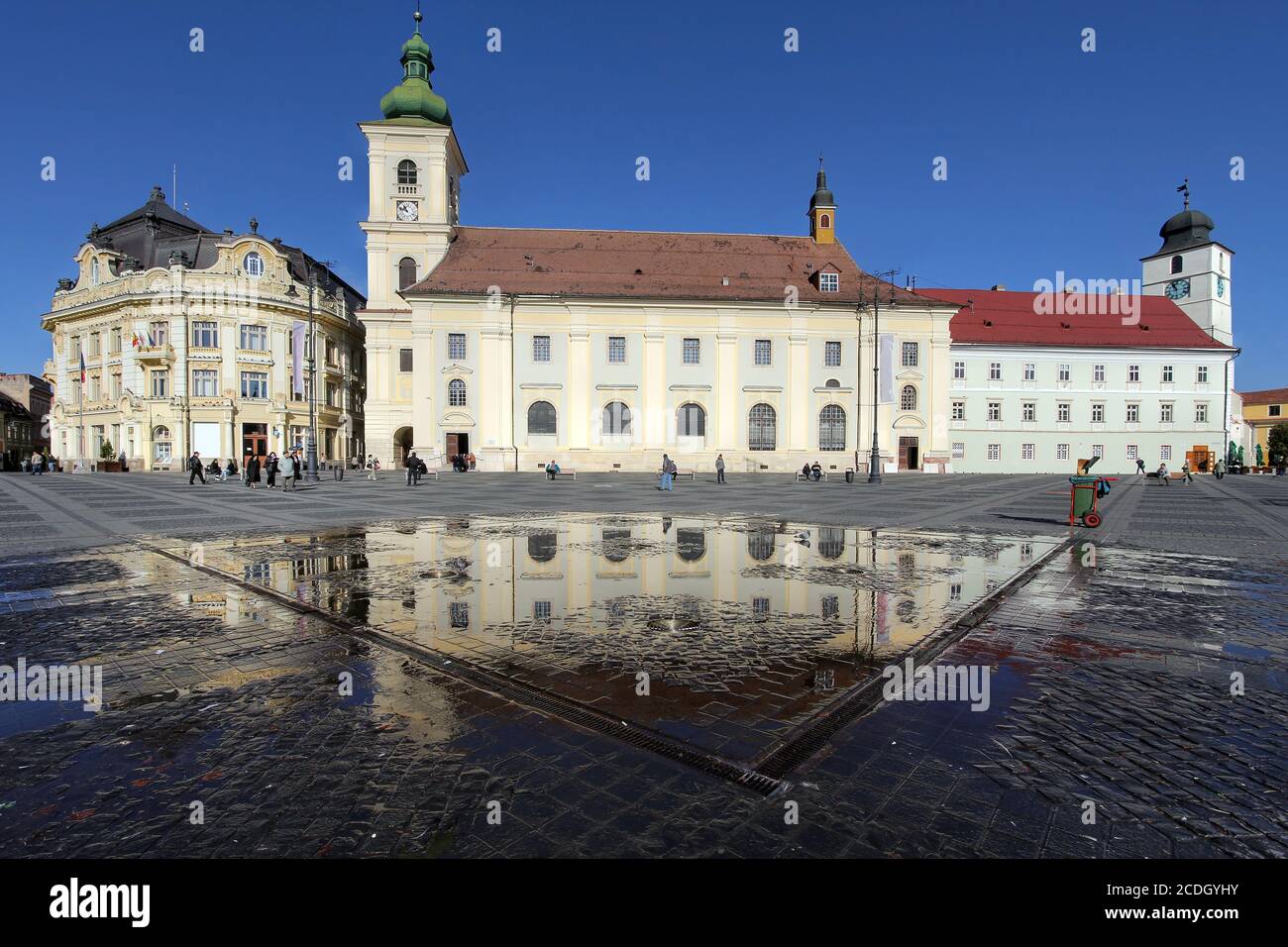 Grand Square (Piata Mare) is the main town square of Sibiu, Romania. Day-time scene capturing on the left the City Hall, the Catholic Church and the r Stock Photo