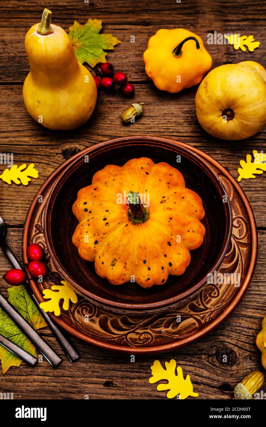 Autumn and Thanksgiving dinner place setting. Harvest of pumpkins and ...