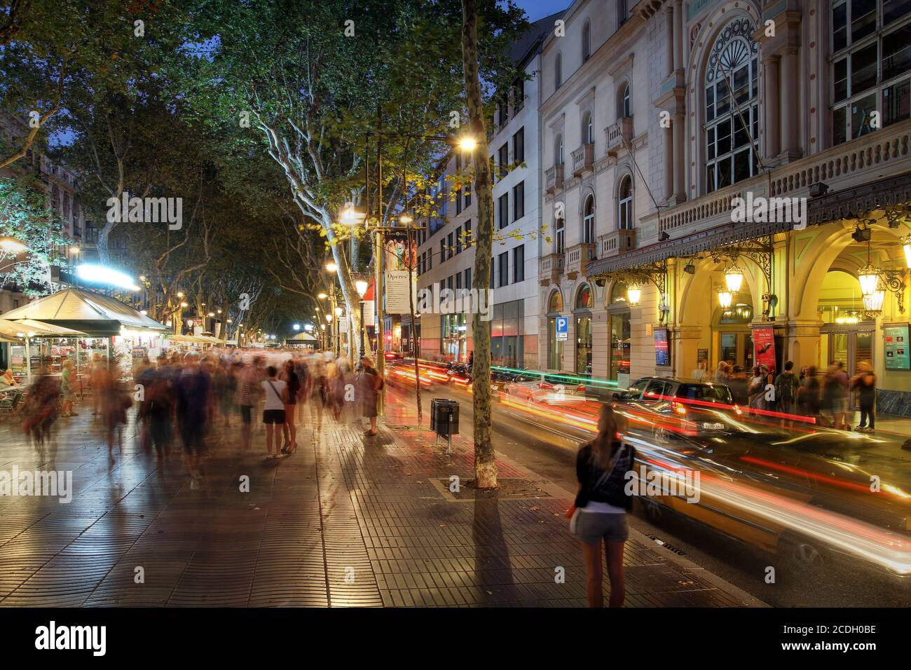 Crowded La Rambla street at the heart of Barcelona, Spain at night time with the Liceu Theatre on the right. Stock Photo