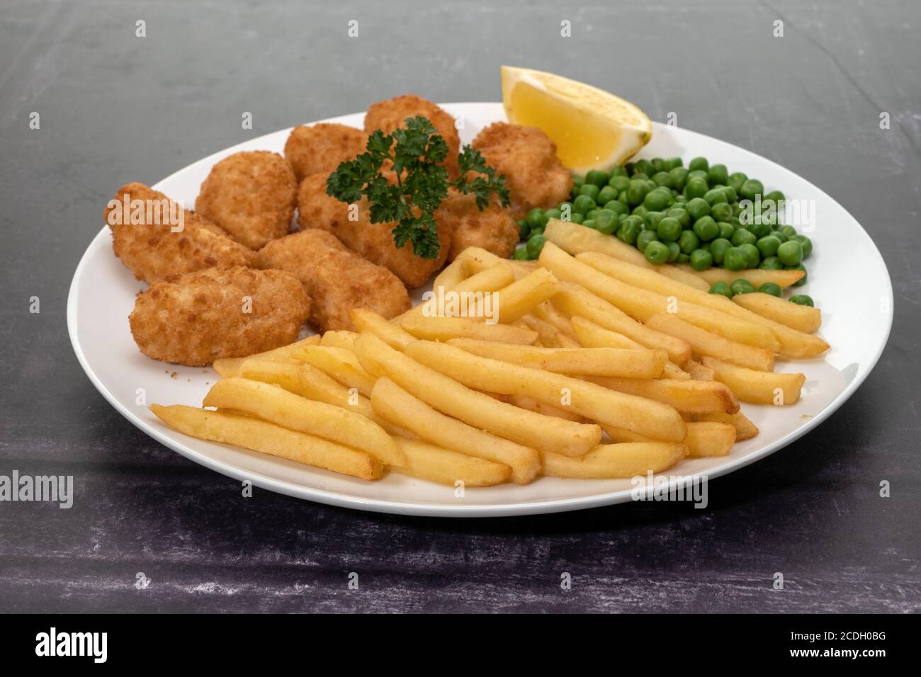 Breaded scampi with peas and potato fries Stock Photo - Alamy