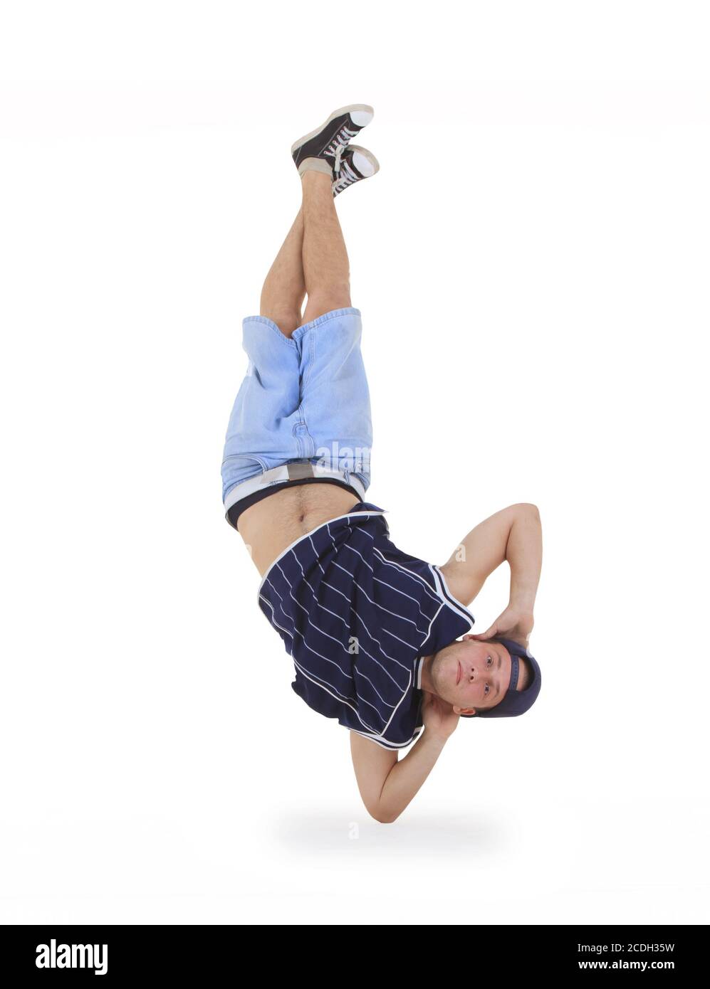 young male dancer performing a bboying stunt Stock Photo