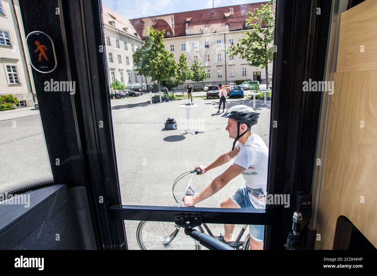 August 28, 2020, Munich, Bavaria, Germany: A member of the Munich Bereitschaftspolizei rides a bicycle to trigger the turning assistant systems.  Bavarian Interior Minister Joachim Herrmann alongside the Bavarian Police revealed service vehicles outfitted with the new turning assistant (Abbiegassistent) devices.  In 2018 alone 455 bicyclists were killed, with trucks turning blind as one preventable cause.  The turning assistant systems are currently voluntary, but in 2022 will become mandatory for old and new trucks and in 2024 for all vehicles as part of an EU-wide safety program. (Credit Ima Stock Photo