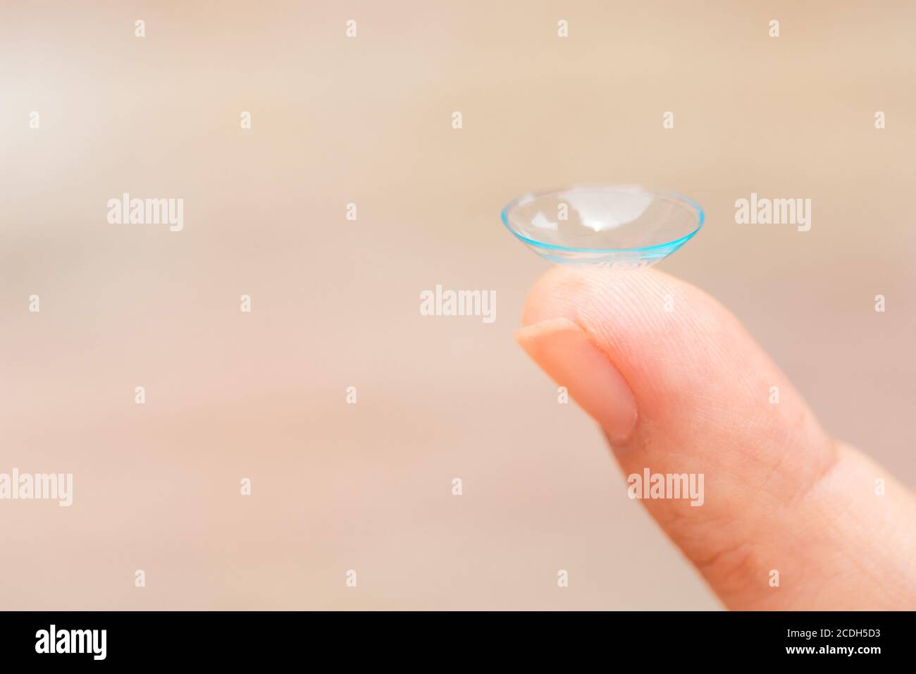 Closeup female finger with contact lens. Contact lenses on a finger. Stock Photo