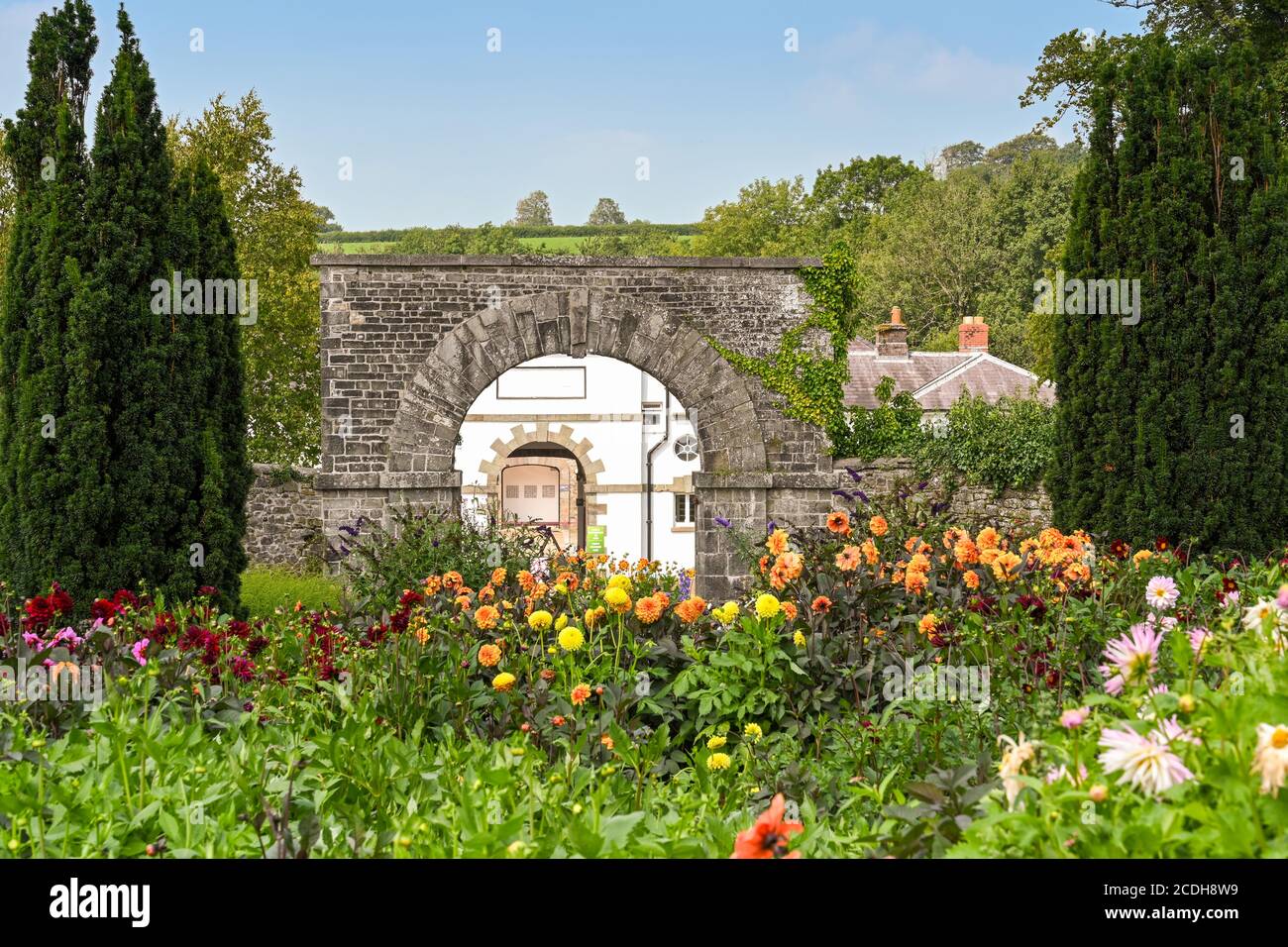 Carmarthen, Wales - August 2020: Flowers and arched gateway in the landscaped grounds of  the National Botanical Garden of Wales Stock Photo
