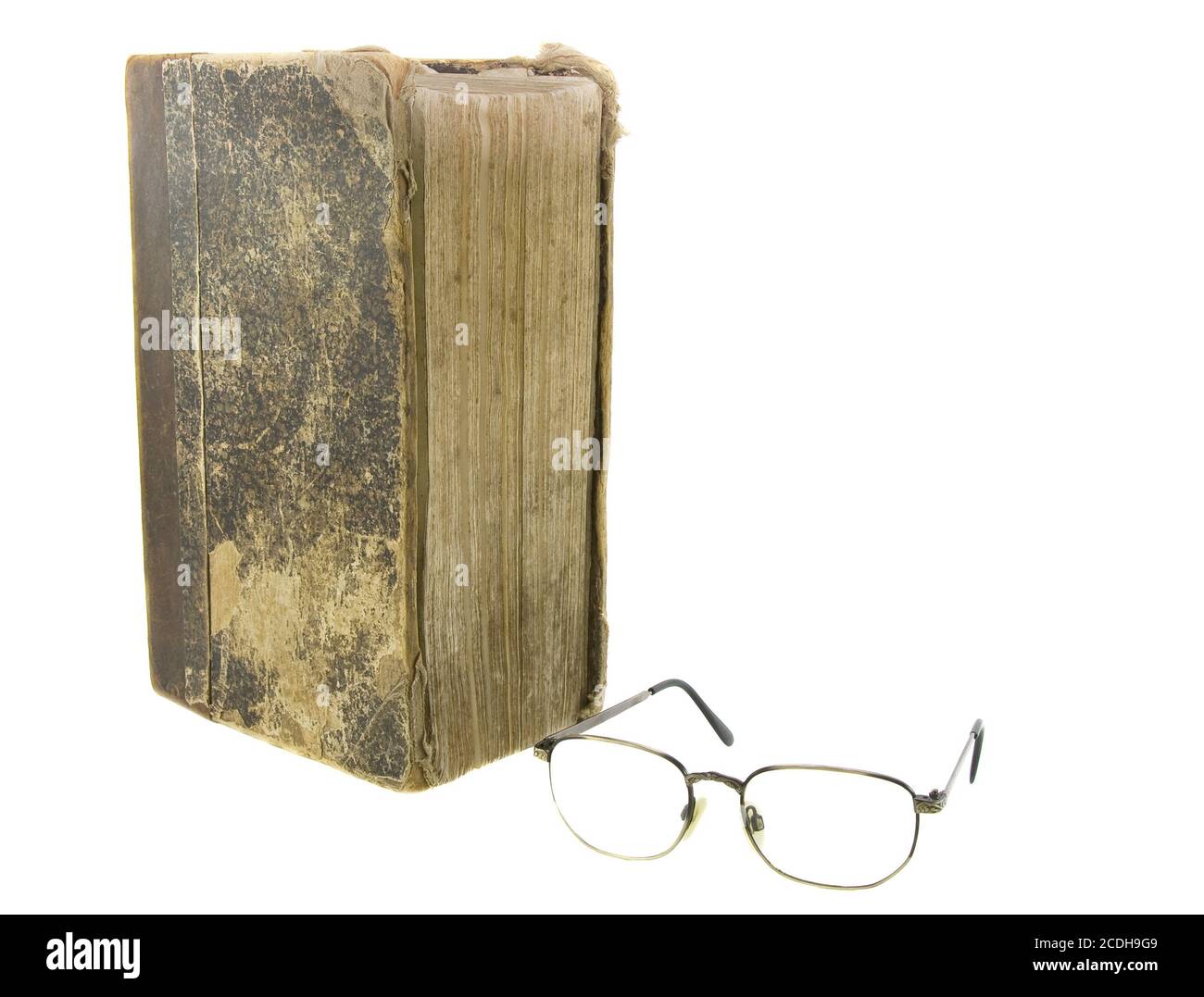 Glasses near very old bible on the white background Stock Photo