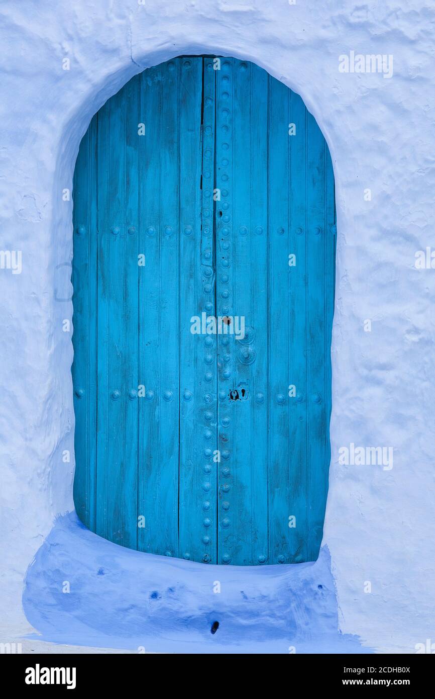 An old wooden door painted blue in Chefchaouen, Morocco Stock Photo