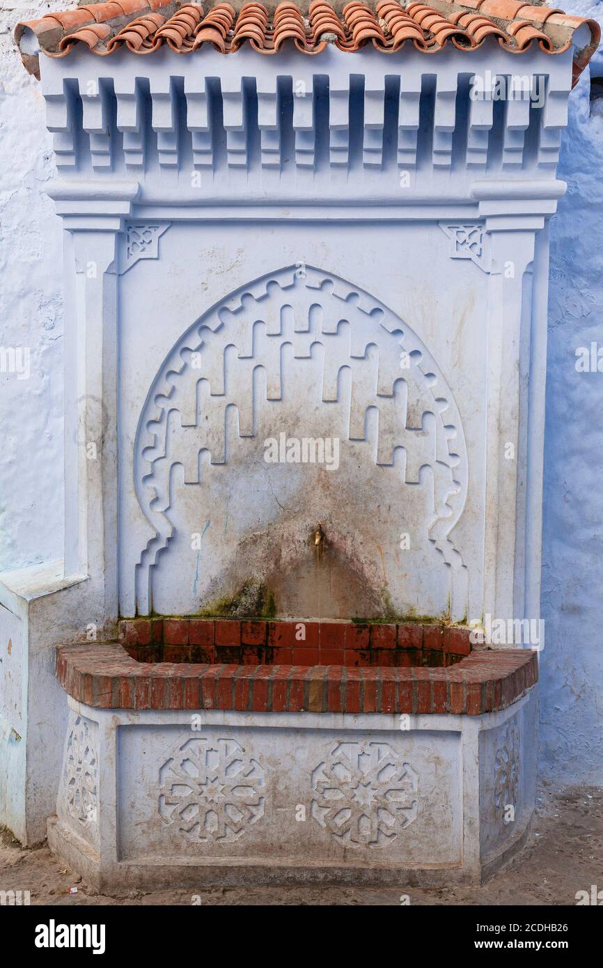 A water fountain in the colourful village of Chefchaouen, Morocco Stock Photo