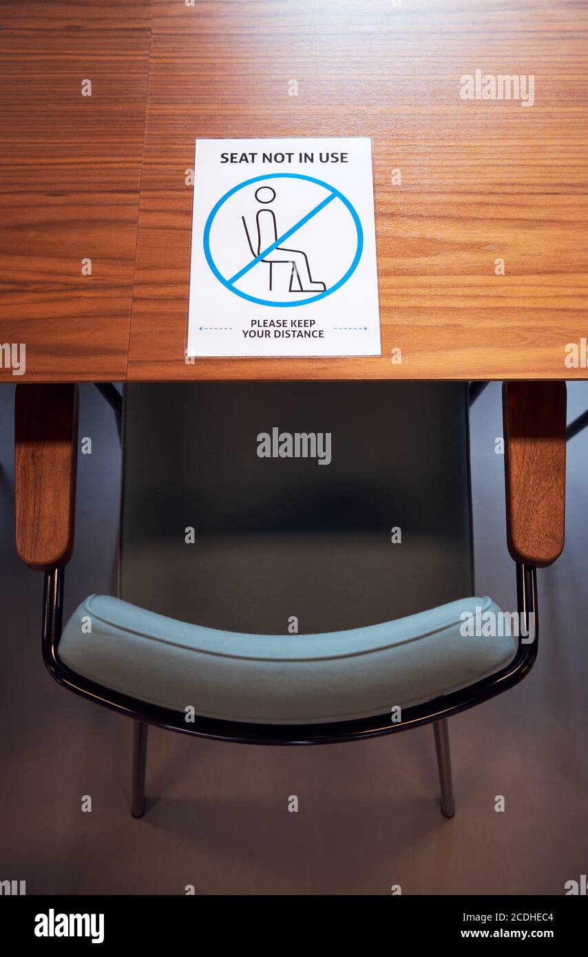 Social distancing sign in office on meeting room table. Stock Photo