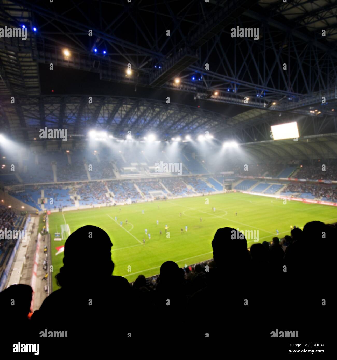 Silhouettes of fans celebrating a goal on football / soccer match Stock Photo