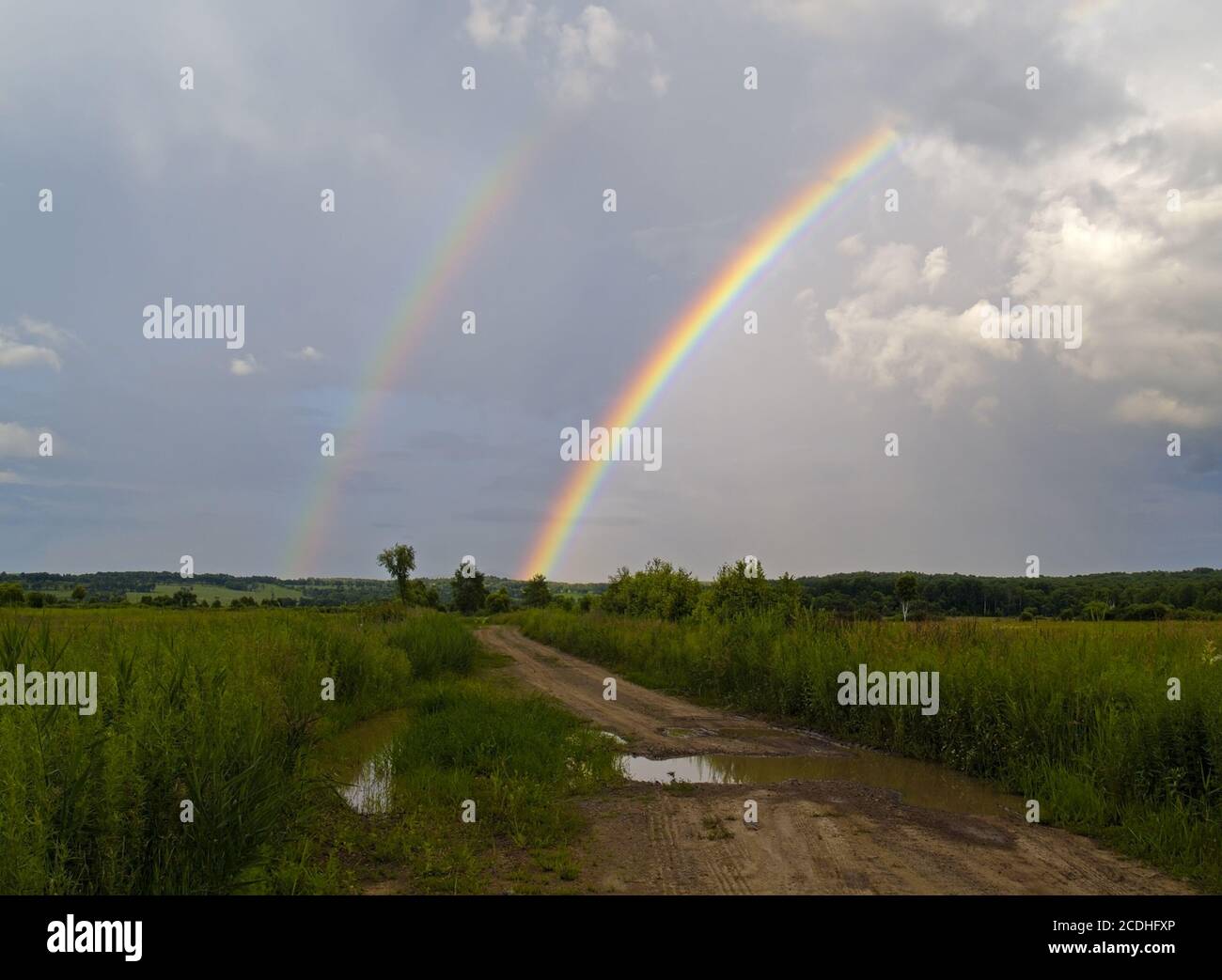 Summer landscape with road and a rainbow Stock Photo - Alamy