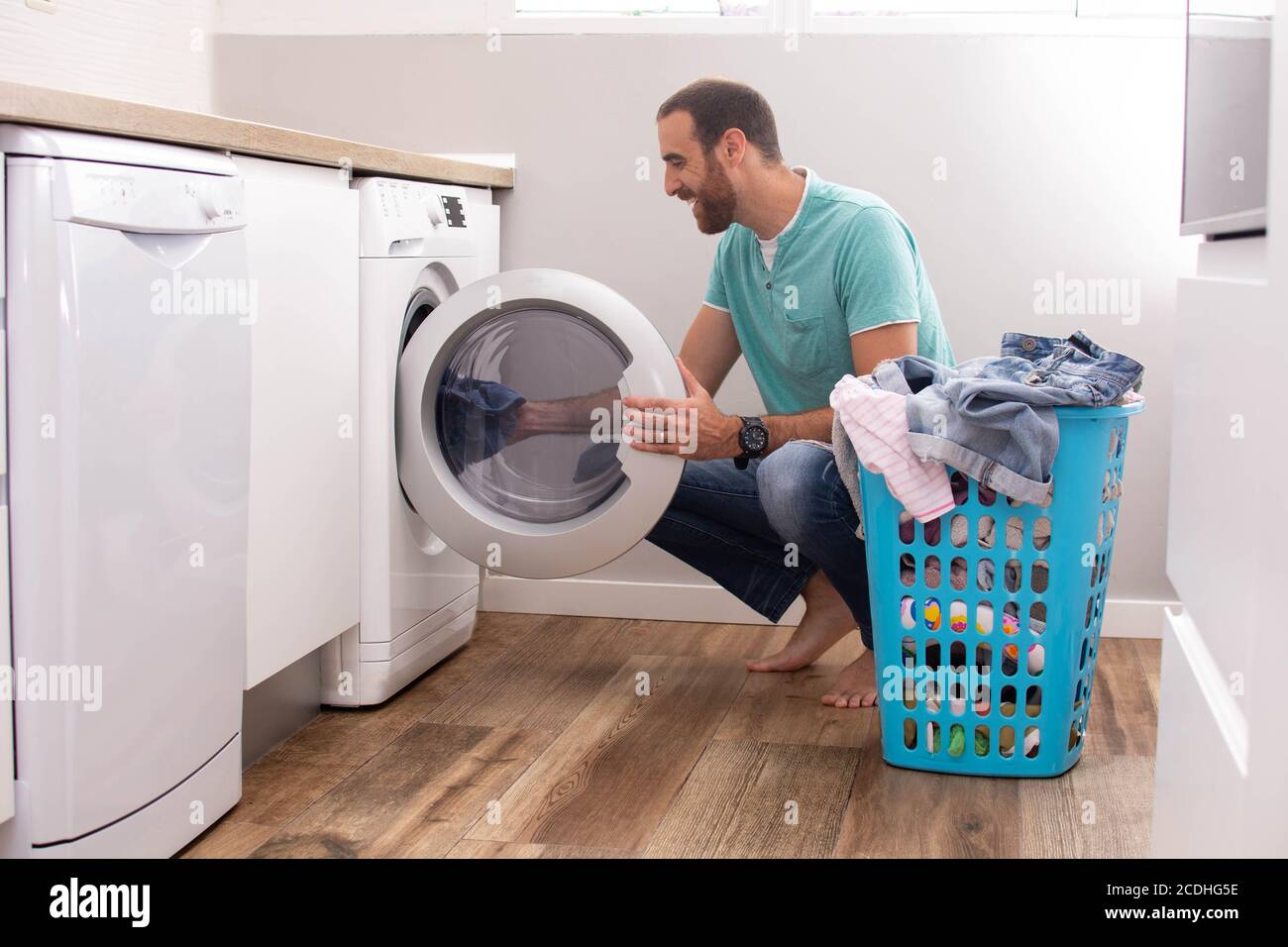 Man doing laundry at home Stock Photo Alamy