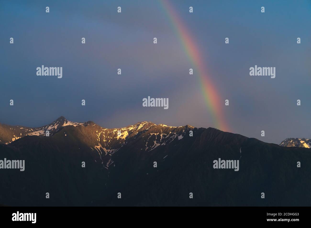 Scenic rainbow over Austrian alp mountains during last rays of sunset, Mieminger Plateau, Tyrol, Austria Stock Photo