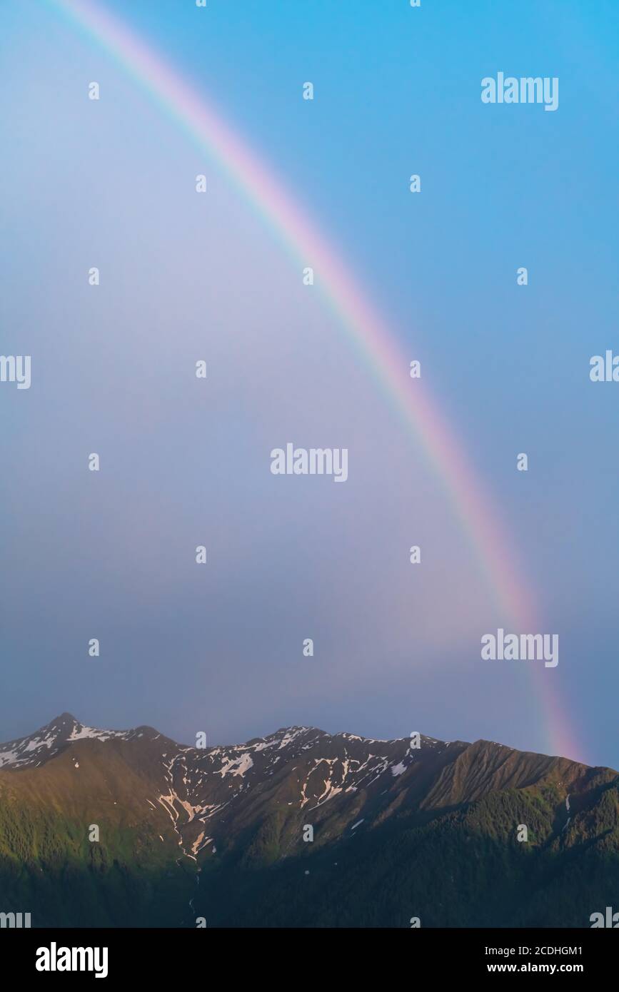 Scenic rainbow over Austrian alp mountains during sunset, Mieminger Plateau, Tyrol, Austria Stock Photo