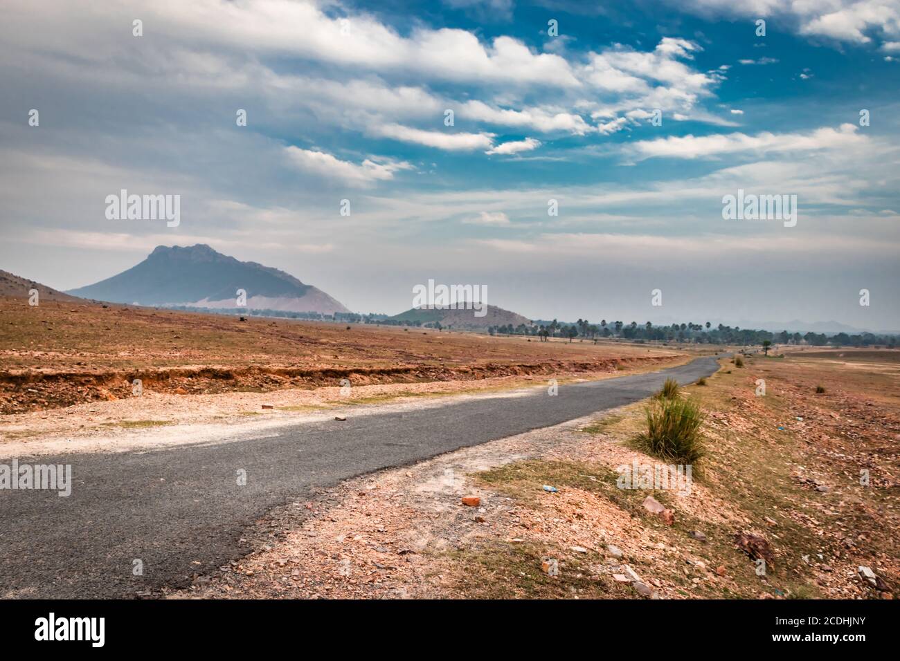 countryside empty rural road with mist and surrounded by mountains at morning image is taken at dashrath manjhi path gaya bihar India. It is showing t Stock Photo