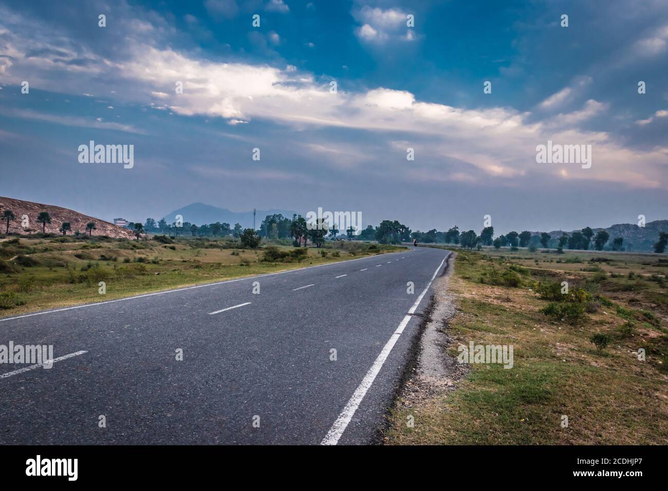 countryside empty rural road with mist and surrounded by mountains at morning image is taken at dashrath manjhi path gaya bihar India. It is showing t Stock Photo
