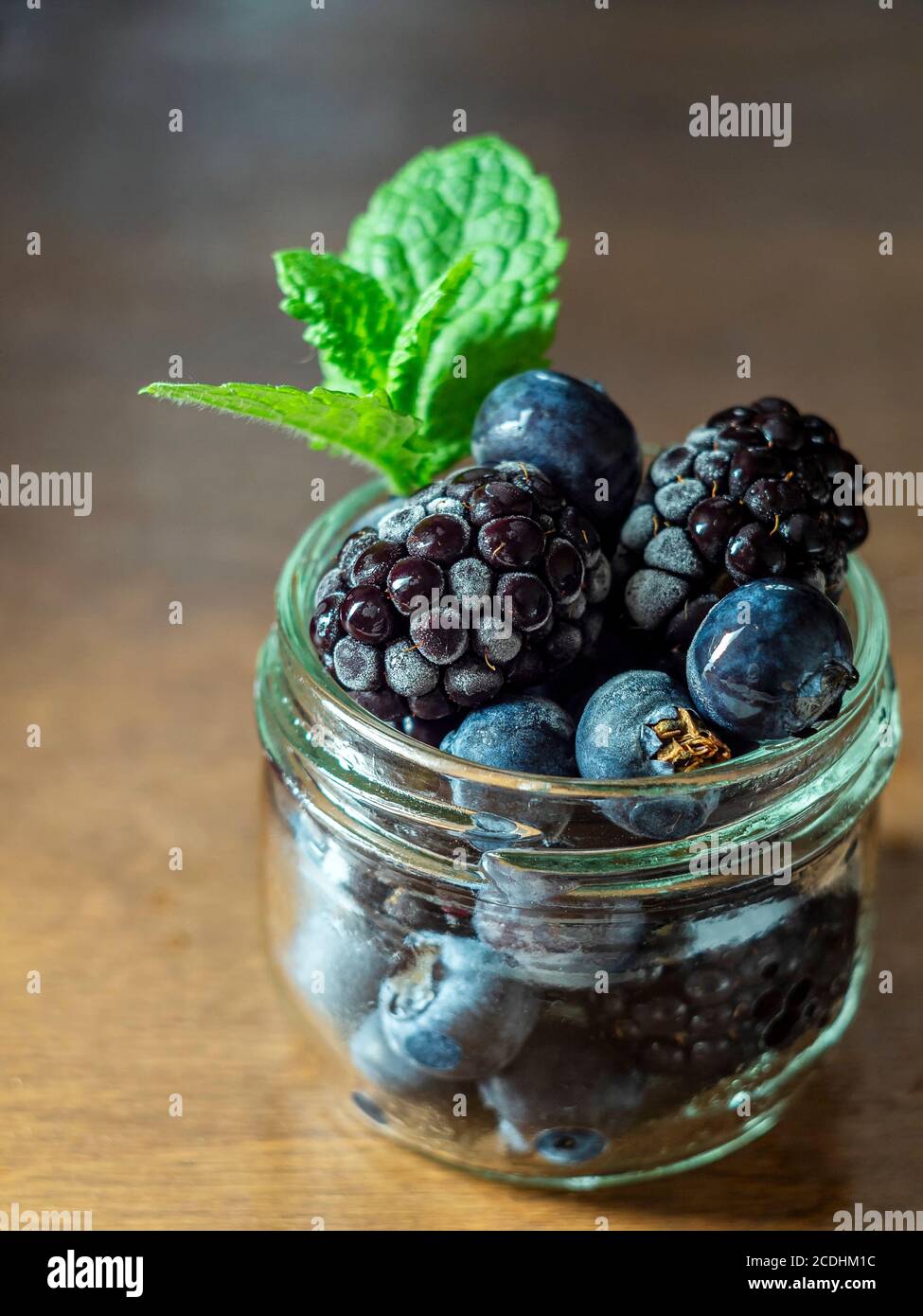 Frozen blackberry and blueberry berries, closeup. Selective focus, copy space. Stock Photo