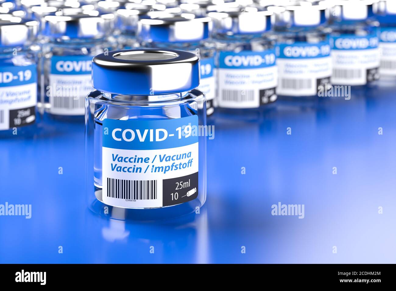 Concept for availability of enough vaccine against Covid-19: Bottles of vaccination. The word vaccination in English, Spanish, French and German on th Stock Photo