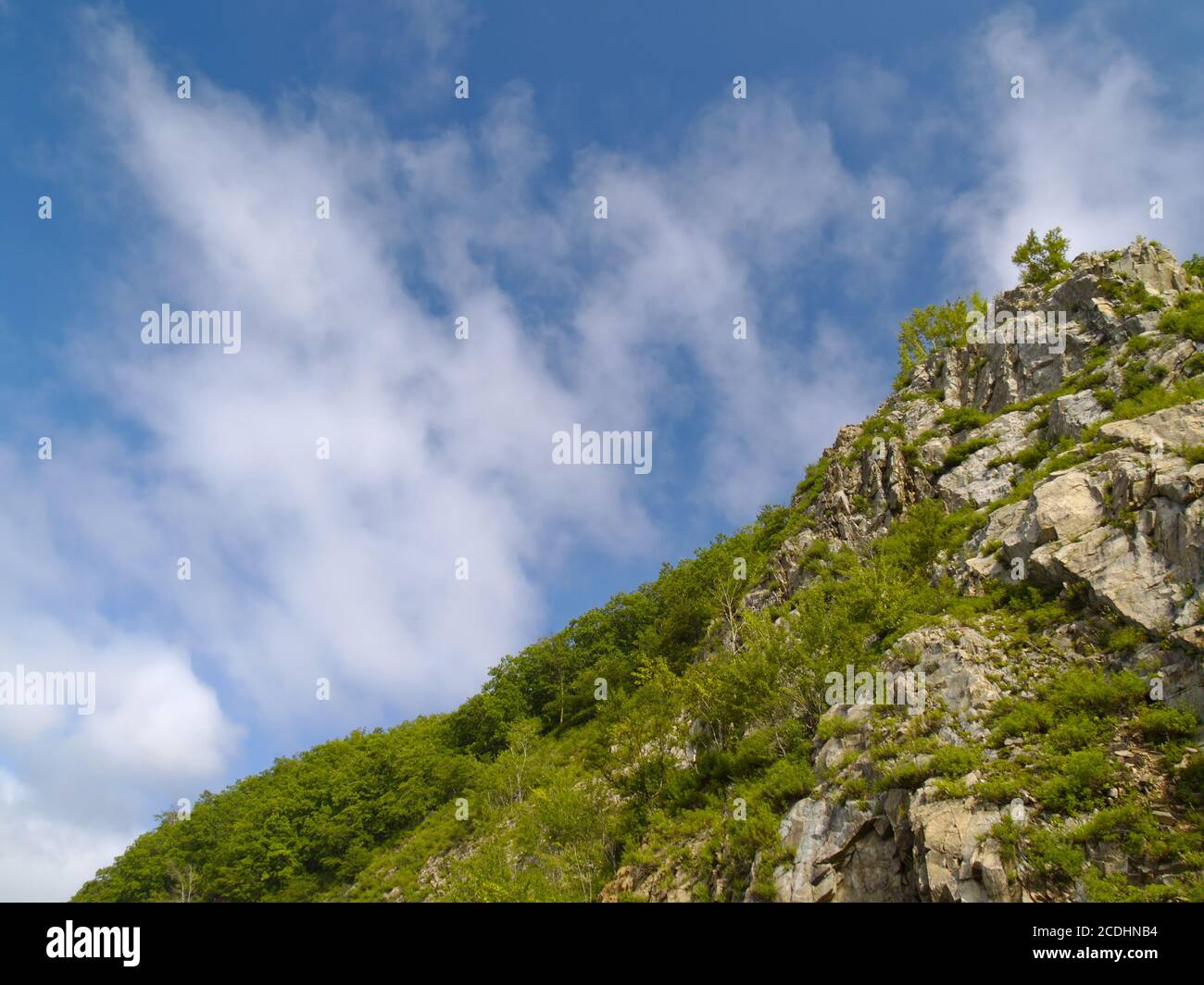 Stone declivity of mountain under cloudy sky Stock Photo