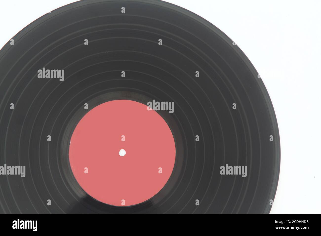 12-inch LP vinyl record disk with blank red label. Close-up shot, top ...