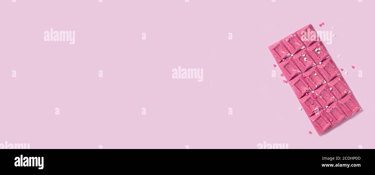 Handmade trendy pink or ruby chocolate. Banner Stock Photo