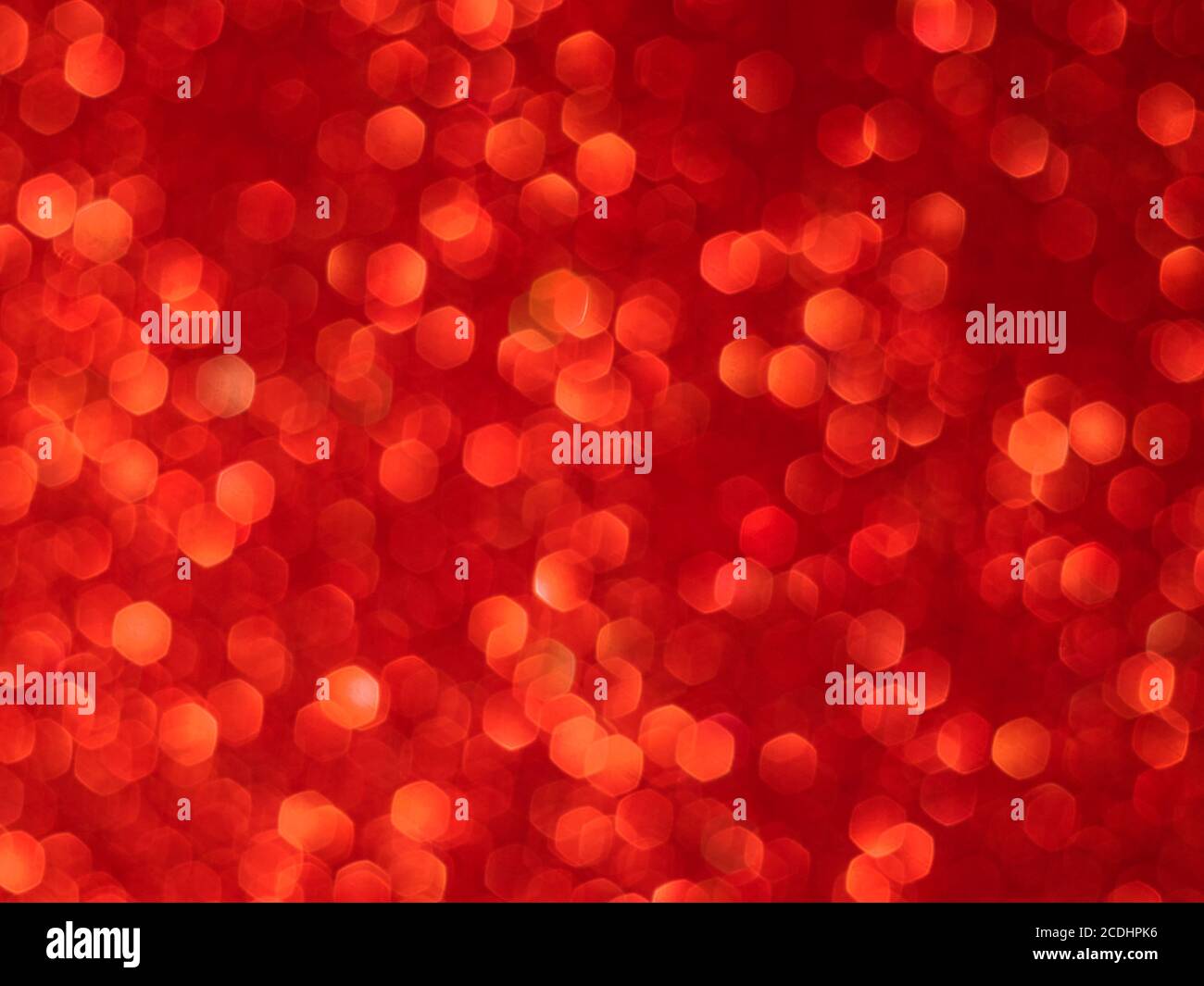 Red bokeh holiday textured glitter background. Blurred abstract holiday background. Stock Photo