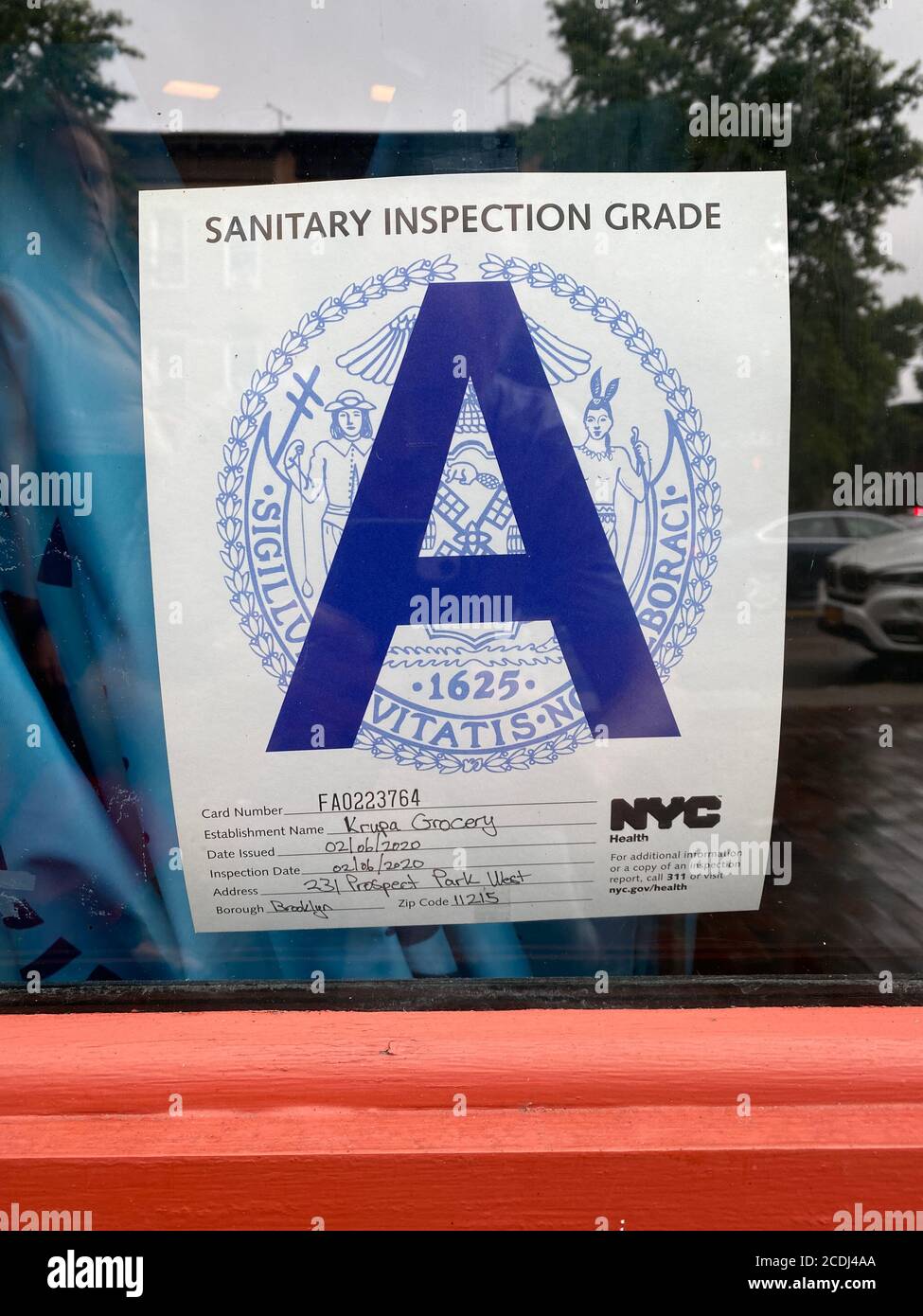 A rating certificate posted in a restaurant window in New York City where establishments get Sanitary Inspection Grades letting customers know the outcome. Grades are A, B and C and are publicly posted. If there are more violations restaurant is closed down. Stock Photo