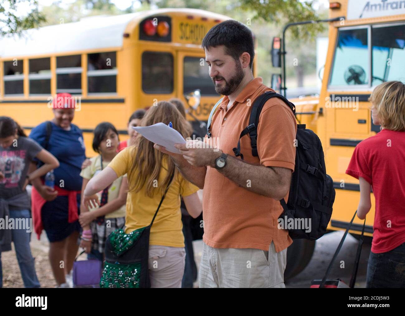 Austin, TX November 18, 2007: Teacher takes roll during the eighth grade field trip to the Barton Creek greenbelt, a 4-mile walk through an urban wilderness that finishes at Barton Springs and Zilker Park. ©Bob Daemmrich Stock Photo