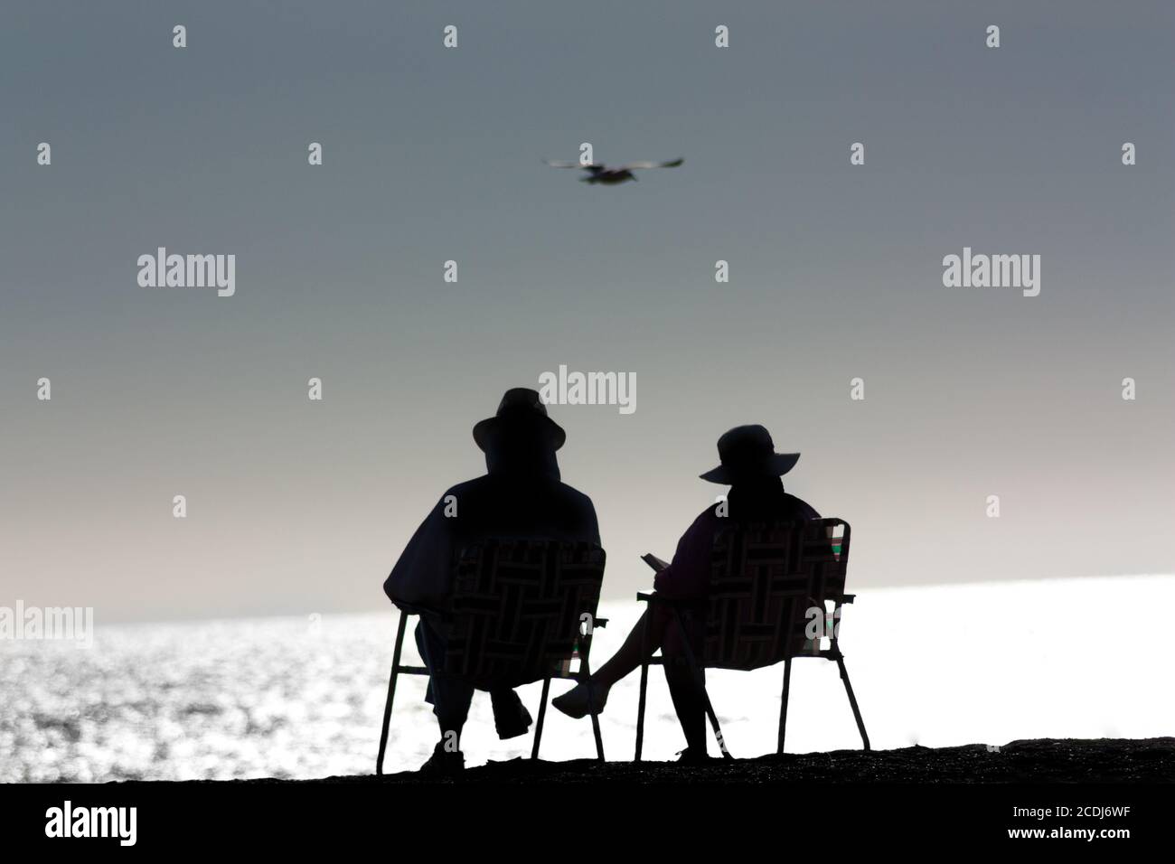 Senior Couple Relaxing at the Beach Stock Photo - Alamy