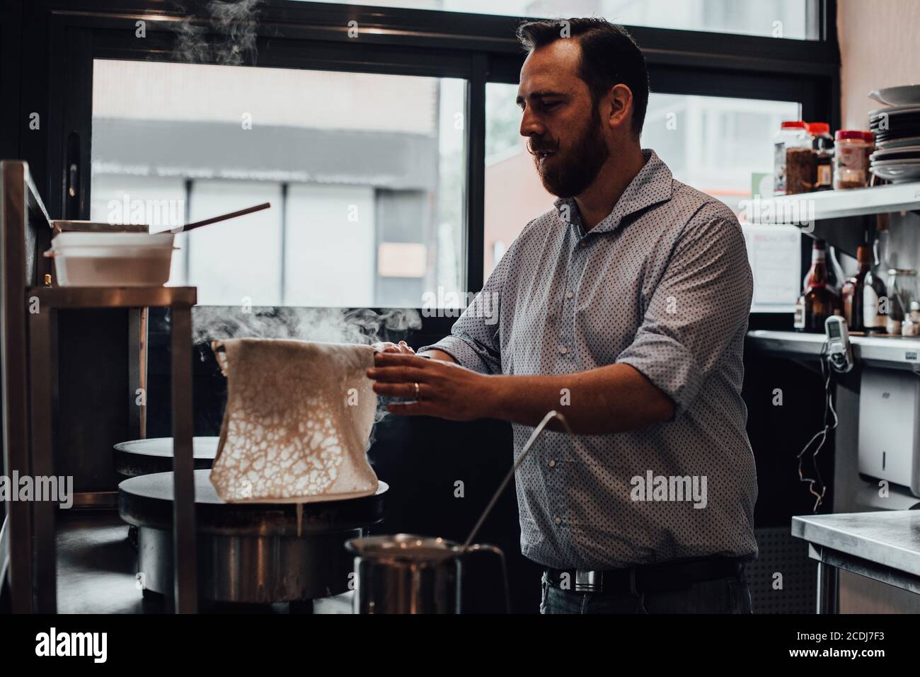 Male chef preparing crepes in restaurant kitchen Stock Photo Alamy
