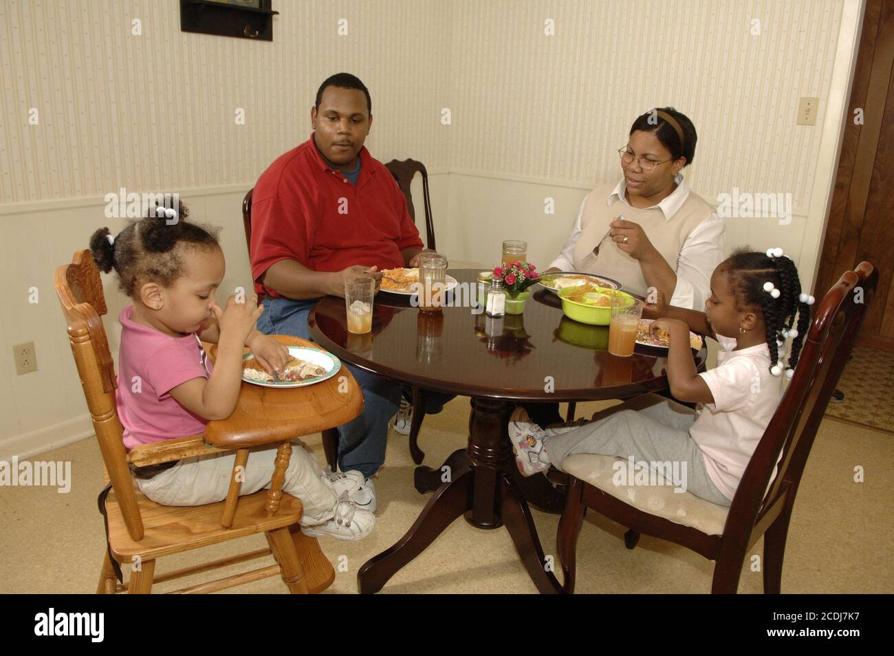 Pine Bluff, AR  October 16, 2006: African-American family with young children having Mexican food take-out dinner at home. ©Bob Daemmrich Stock Photo