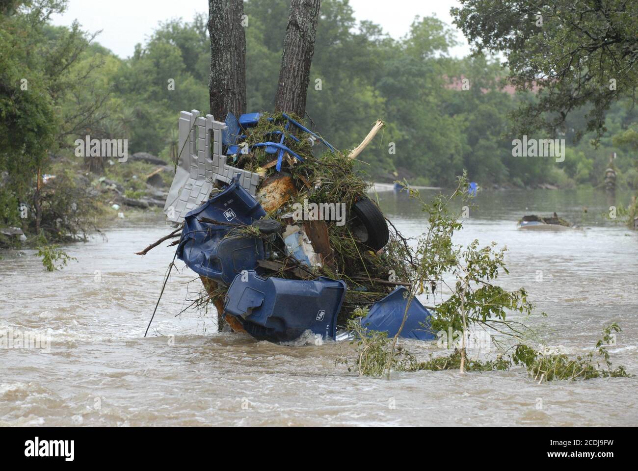 Marble Falls, TX  June 27, 2007: Debris stacks against a tree in Whitman Branch Creek after up to 19 inches of rain in a few hours fell on the Marble Falls area. Flash flooding along the creek resulted in property damage in the millions. No deaths were reported. ©Bob Daemmrich Stock Photo
