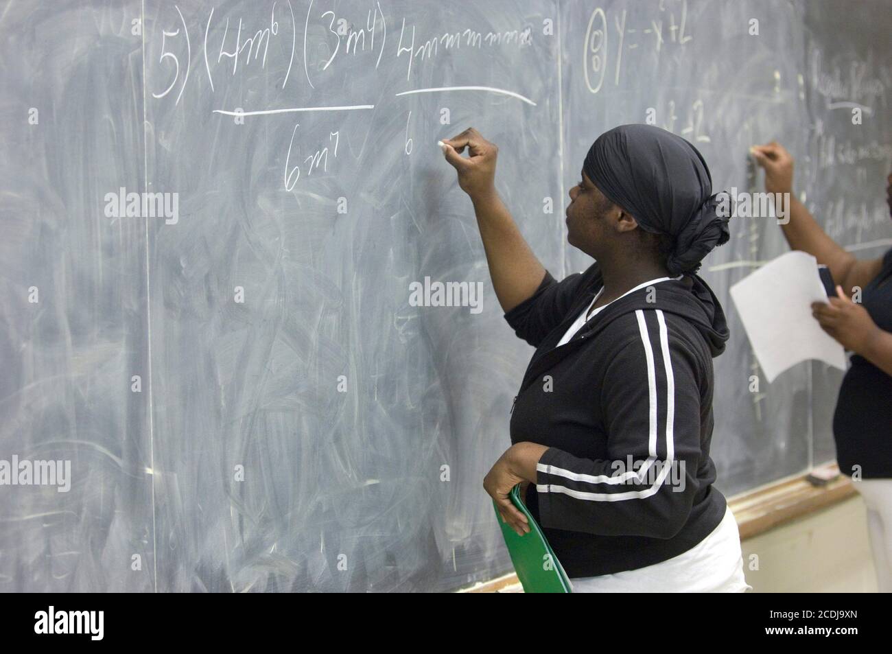 Houston, TX May 17, 2007: Algebra student writes out a problem on the board at Jesse Jones High (Houston),  a traditional inner-city high school with 50-50 mix of African-American and Hispanic students.  ©Bob Daemmrich Stock Photo