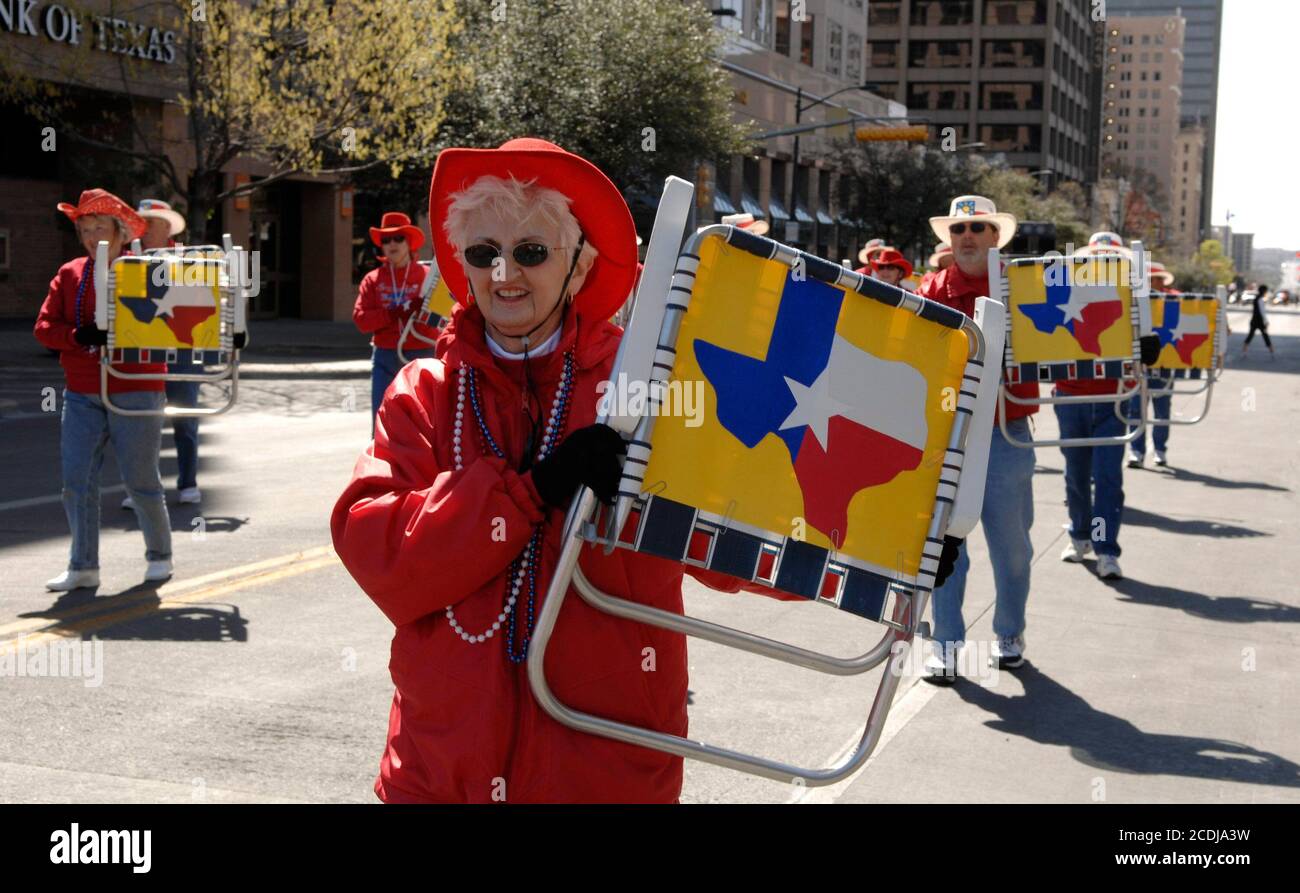 Austin, TX March 3, 2007: A woman in formation shows a Texas flag on a lawn chair as she marches in the Texas Independence Day parade on Congress Avenue celebrating the official March 2nd date of Texas' becoming an independent country following its revolution against Mexican rule. ©Bob Daemmrich Stock Photo