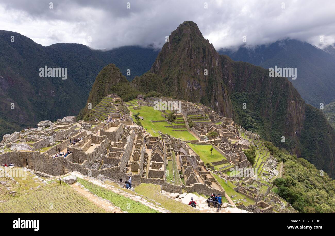 Machu Picchu, Peru - october 06, 2018: View of tourists visiting the ruins of the Lost Incan City of Machu Picchu near Cusco, Peru. Machu Picchu is a Stock Photo