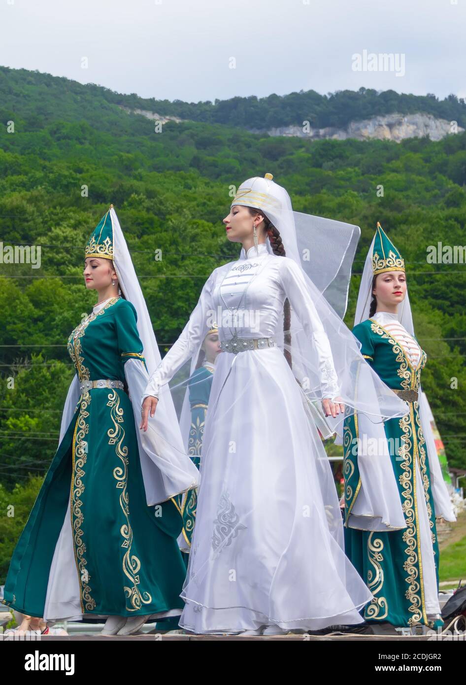 Adygea, RUSSIA - JULY 25 2015: Female dancers in traditional costumes  Circassian green hills in the background. Ethnic festival in the foothills  of th Stock Photo - Alamy