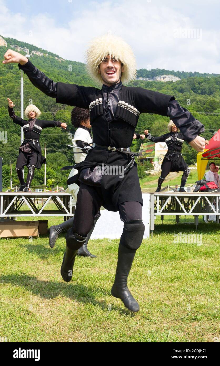 DAKHOVSKY, RUSSIA - JULY 25 2015: The guy the Muslim in a national Adyghe suit dances traditional dance. The Festival 'Lago-Naki: Kunatskaya' was held Stock Photo