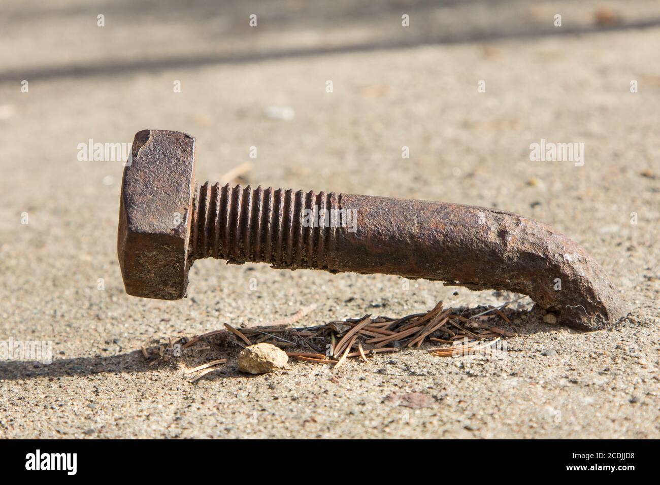 Rusty Bent Lag Bolt in Concrete Stock Photo Alamy