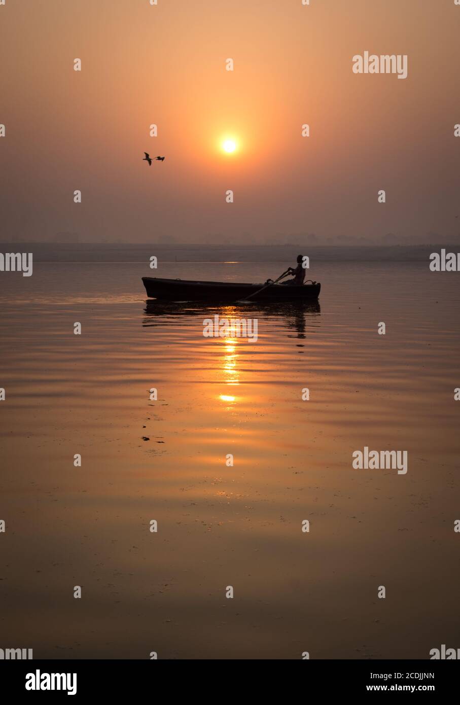 rowing boat in the sunset Stock Photo