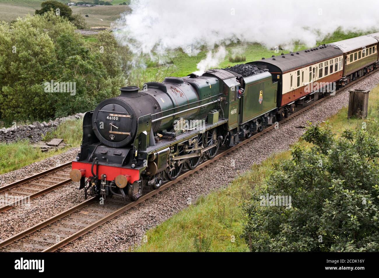 The 'Royal Scot' steam locomotive hauls 'The Fellsman' train on the Settle-Carlisle railway line near Ribblehead in The Yorkshire Dales National Park. Stock Photo