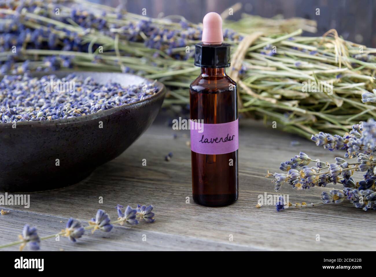 Natural lavender oil on glass dropper bottle and lavender dried flowers Stock Photo