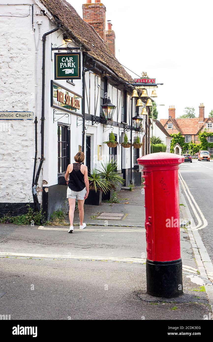 Red royal mail post box outside the six bells pub in the Oxfordshire market town of Thame Stock Photo