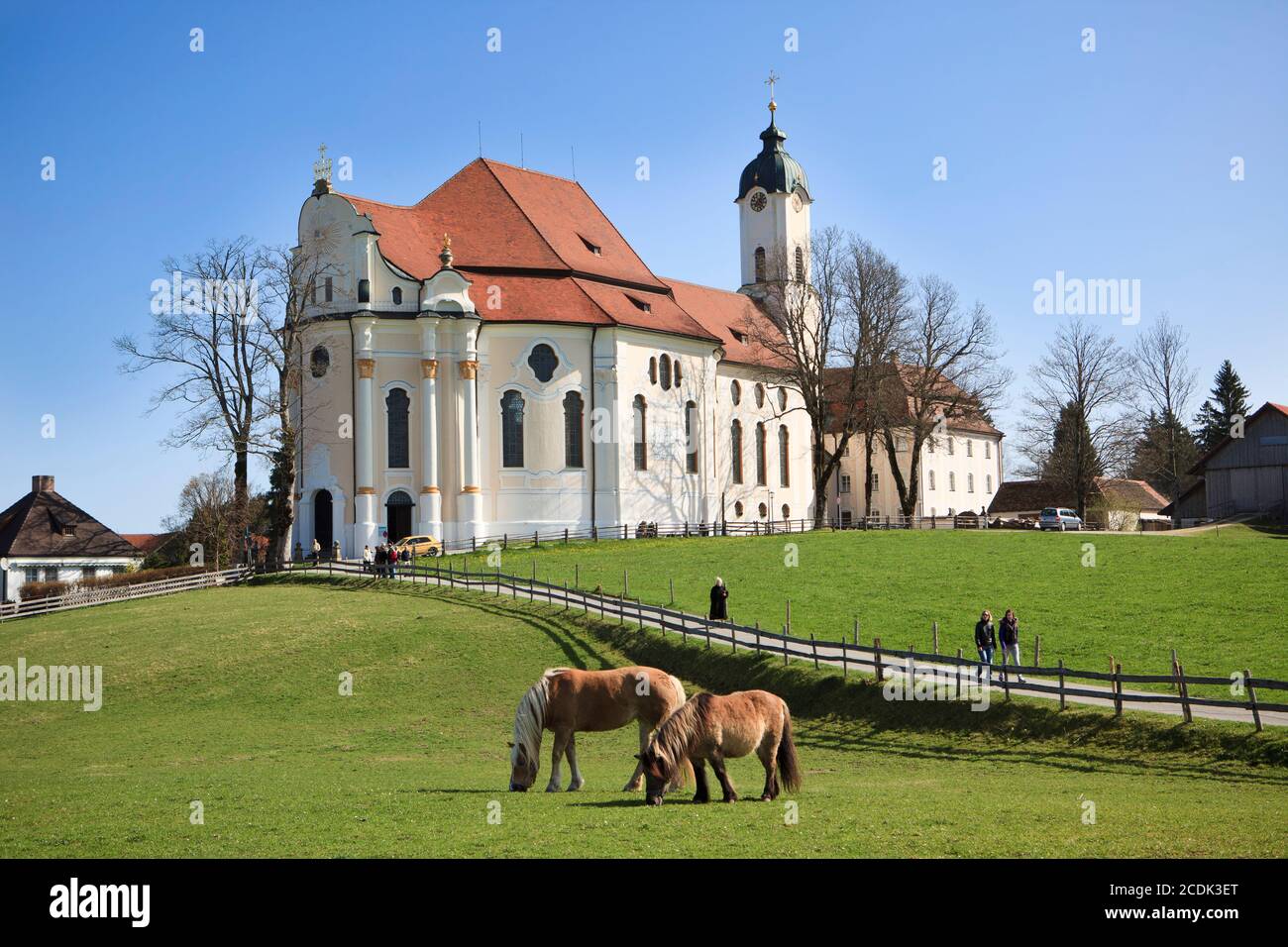 Worshippers leaving the Pilgrimage Church of Wies (Wieskirche) after Sunday mass. The church of Wies is an oval Rococo Church near Steingaden at the f Stock Photo