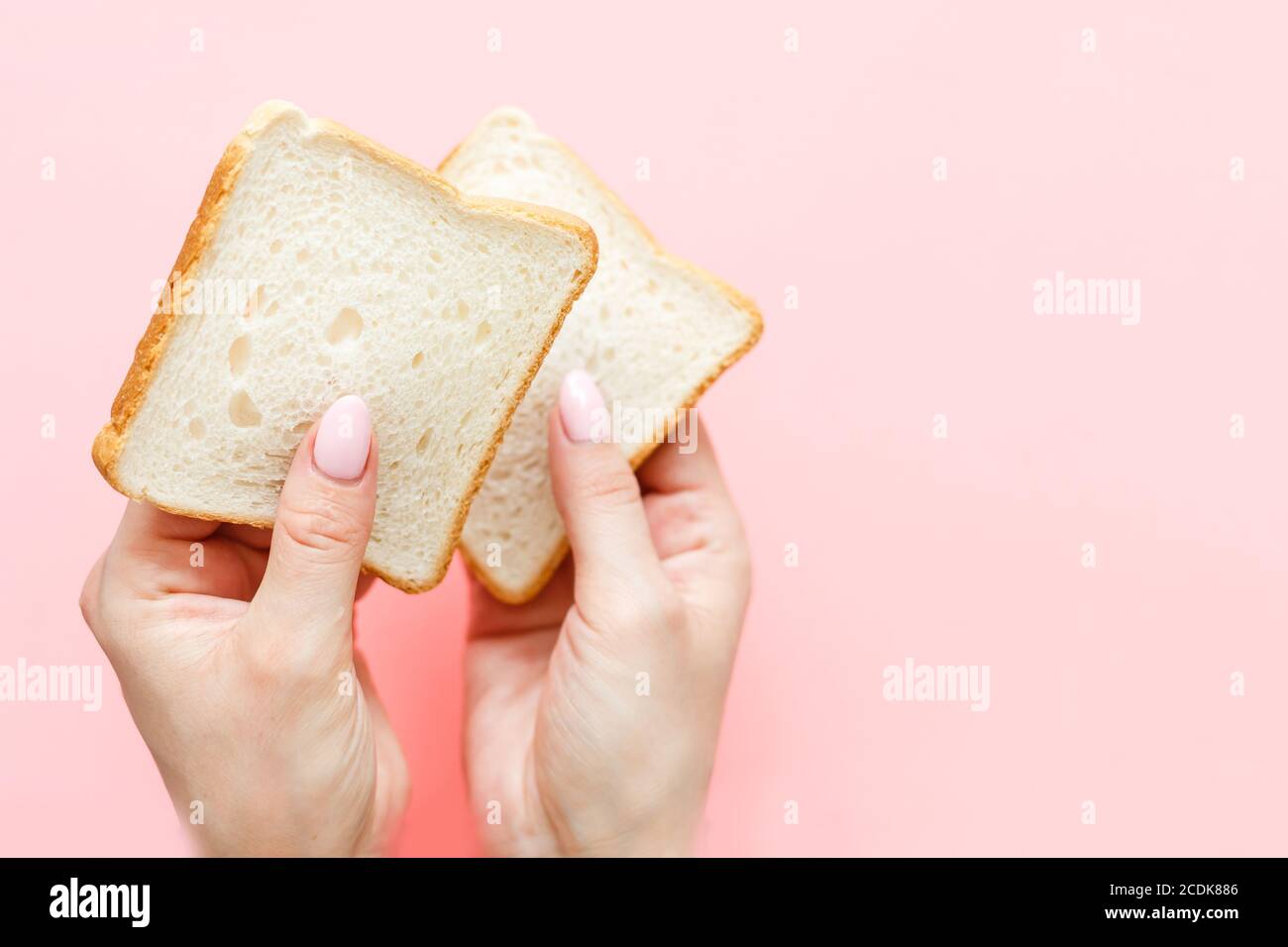 hand holding two slices of bread Stock Photo Alamy