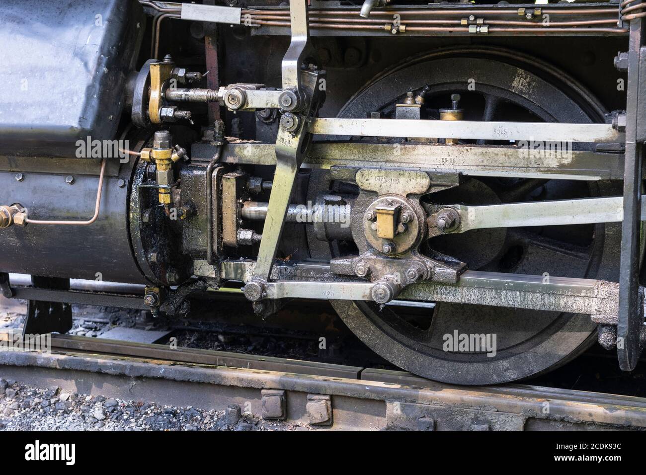 Closeup of a piston and valve gear for an old fashioned steam train from 1914 Klaus no. 6925 on the Steyr Valley Museum narrow gauge railway, Austria Stock Photo