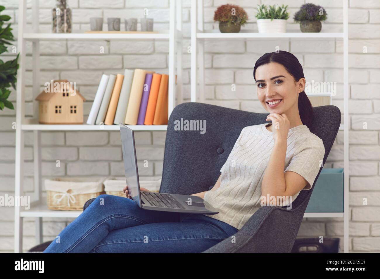 Confident woman working using laptop from home Stock Photo