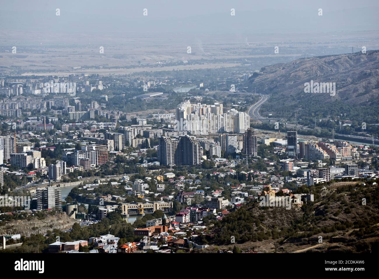 Panoramic view of Tbilisi from Mount Mtatsminda: Sololaki Hill, Kura River and outskirts and suburbs. Republic of Georgia. Stock Photo